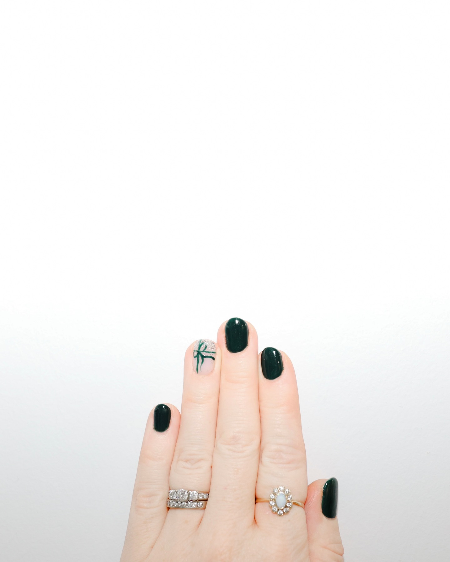 Dark green gel manicure with ribbon accent nail